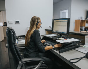 lady at desk using a phone headset